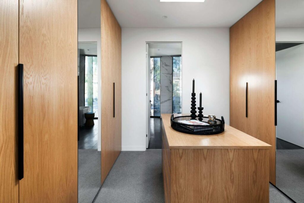 Modern walnut walk-in wardrobe in Brisbane.